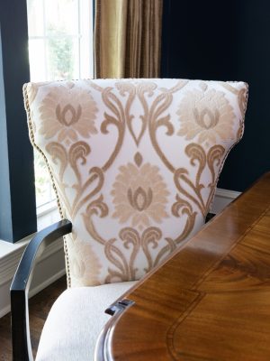 Traditional dining room with custom upholstered chairs, refined finishes, and timeless Dallas interior design